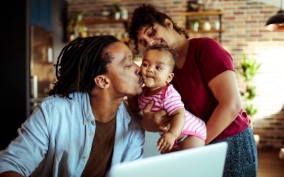 Young Black family using laptop