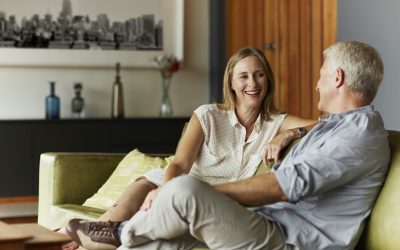 Midlife couple sitting on couch together